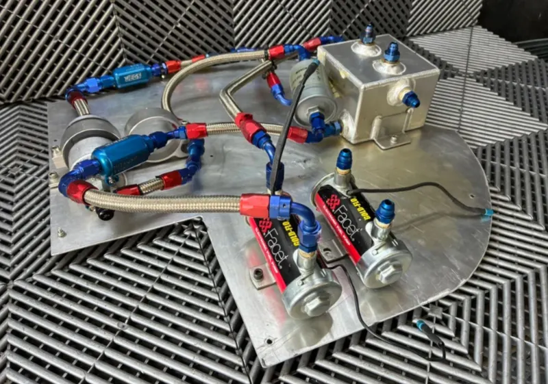 Used. Fuel surge tank and pump assembly mounted on an aluminum baseplate.